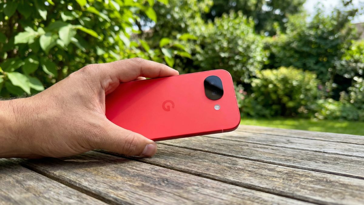 Men holds a Google Pixel 10a showing its camera closely in a forest